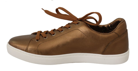 Gold leather men's casual sneakers by Dolce & Gabbana with white rubber soles and stylish design.