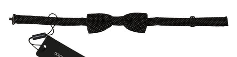 Black silk bow tie with white polka dots, adjustable neck strap, men's fashion accessory by Dolce & Gabbana.
