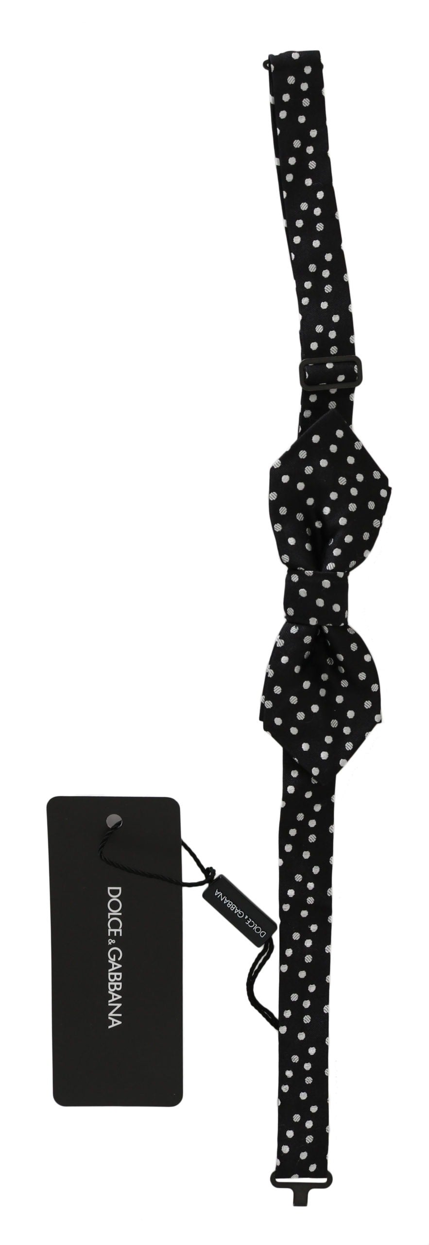 Black silk bow tie with white polka dots, adjustable neck strap, men's accessory by Dolce & Gabbana.