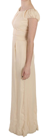 Beige silk column gown with cap sleeves by Dolce & Gabbana, floor-length dress with elegant, smooth fabric and a sleek silhouette.