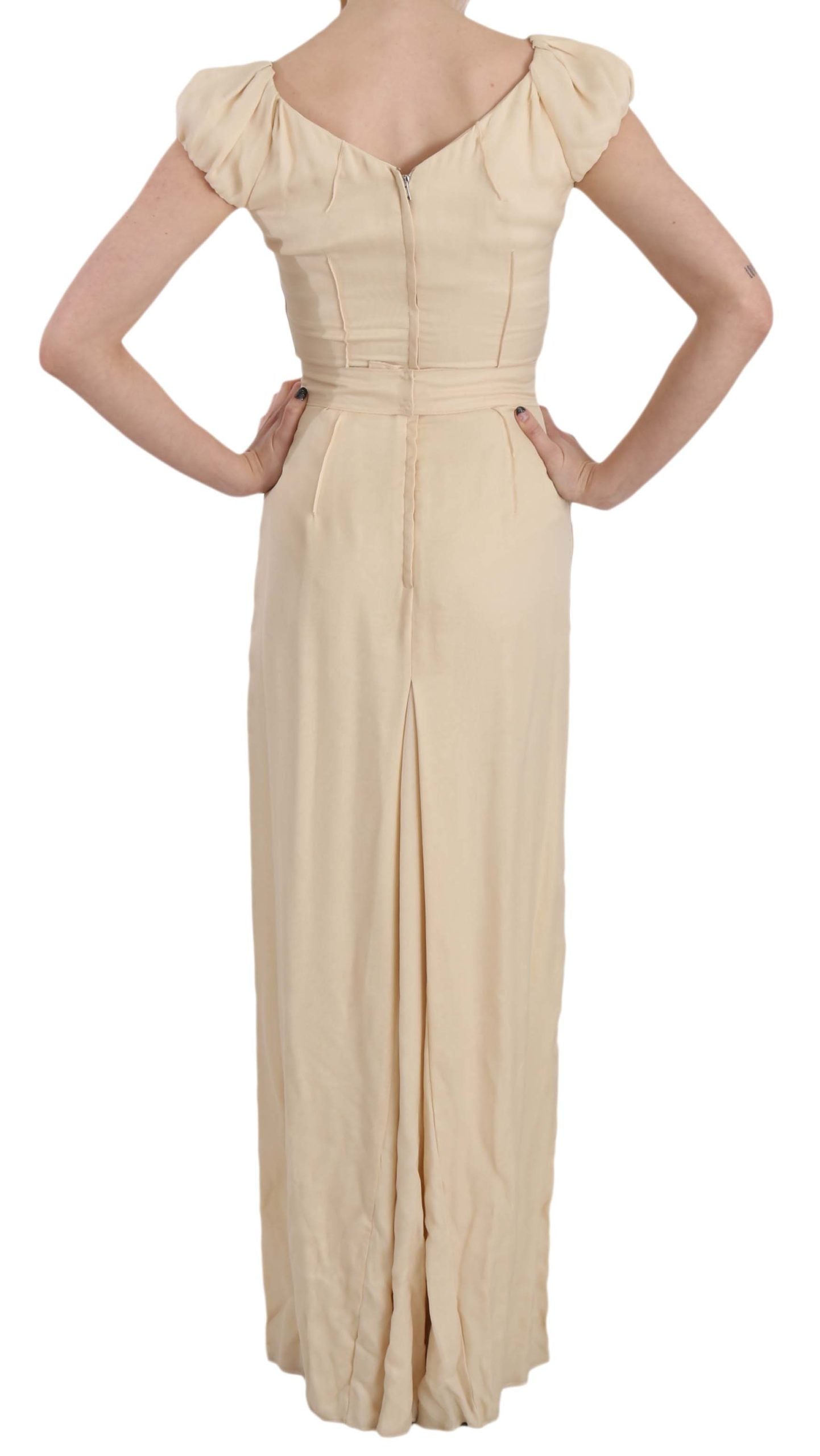 Beige silk column gown with cap sleeves by Dolce & Gabbana, featuring a sleek, elegant silhouette and smooth fabric.