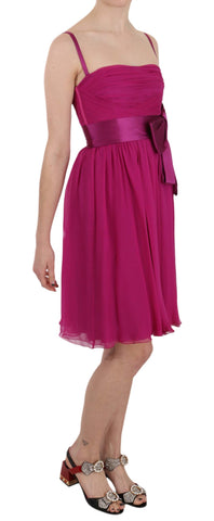 Fuchsia pink silk sleeveless dress with bow detail by Dolce & Gabbana, showcased on a mannequin.
