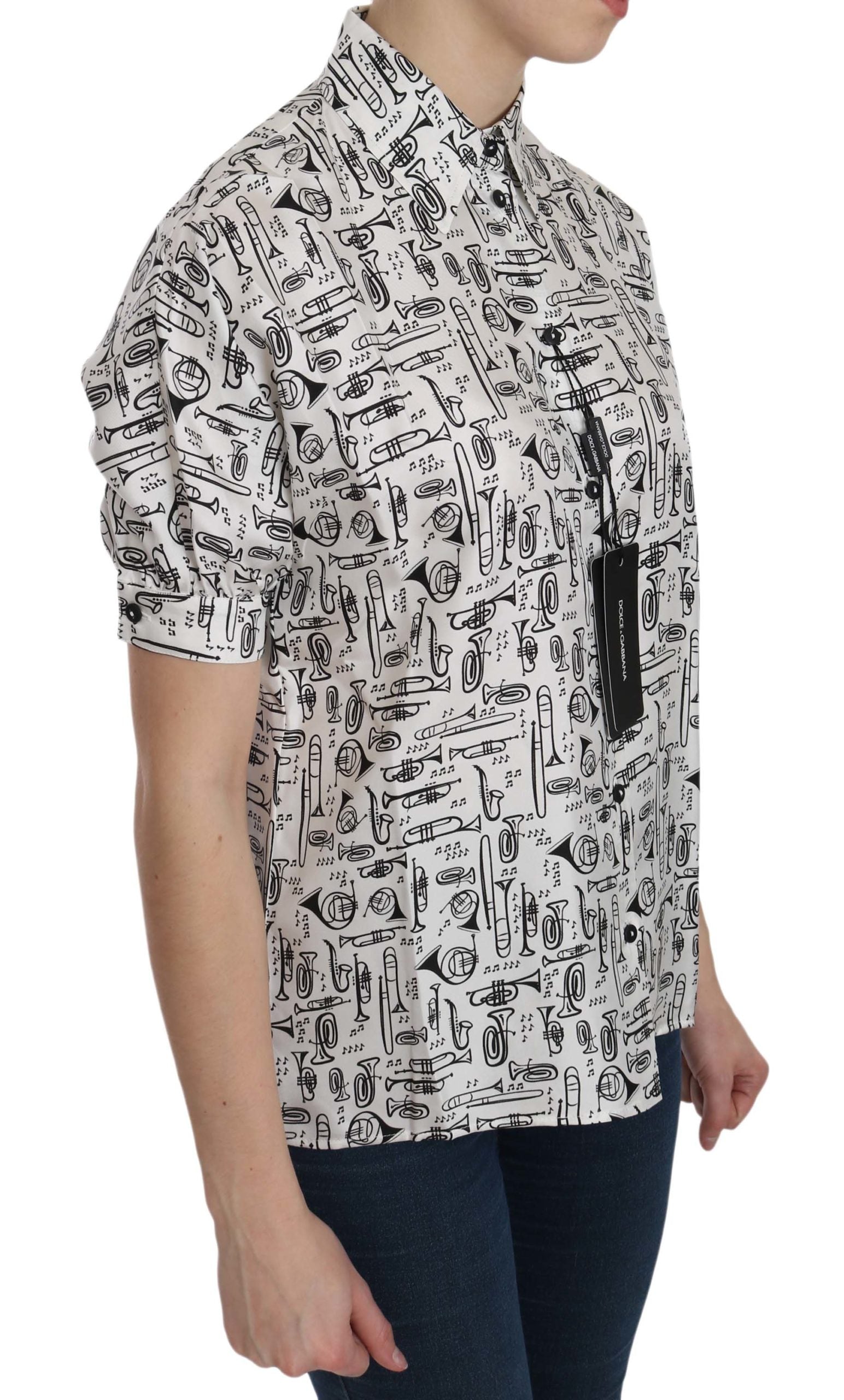 White Dolce & Gabbana collared blouse with musical instrument print, long sleeves, and button front, stylish and elegant.