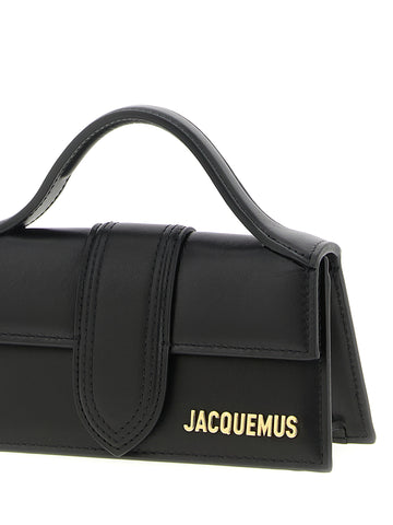 Black Jacquemus cowhide handbag with sleek design and top handle, featuring gold-tone hardware and minimalist style.