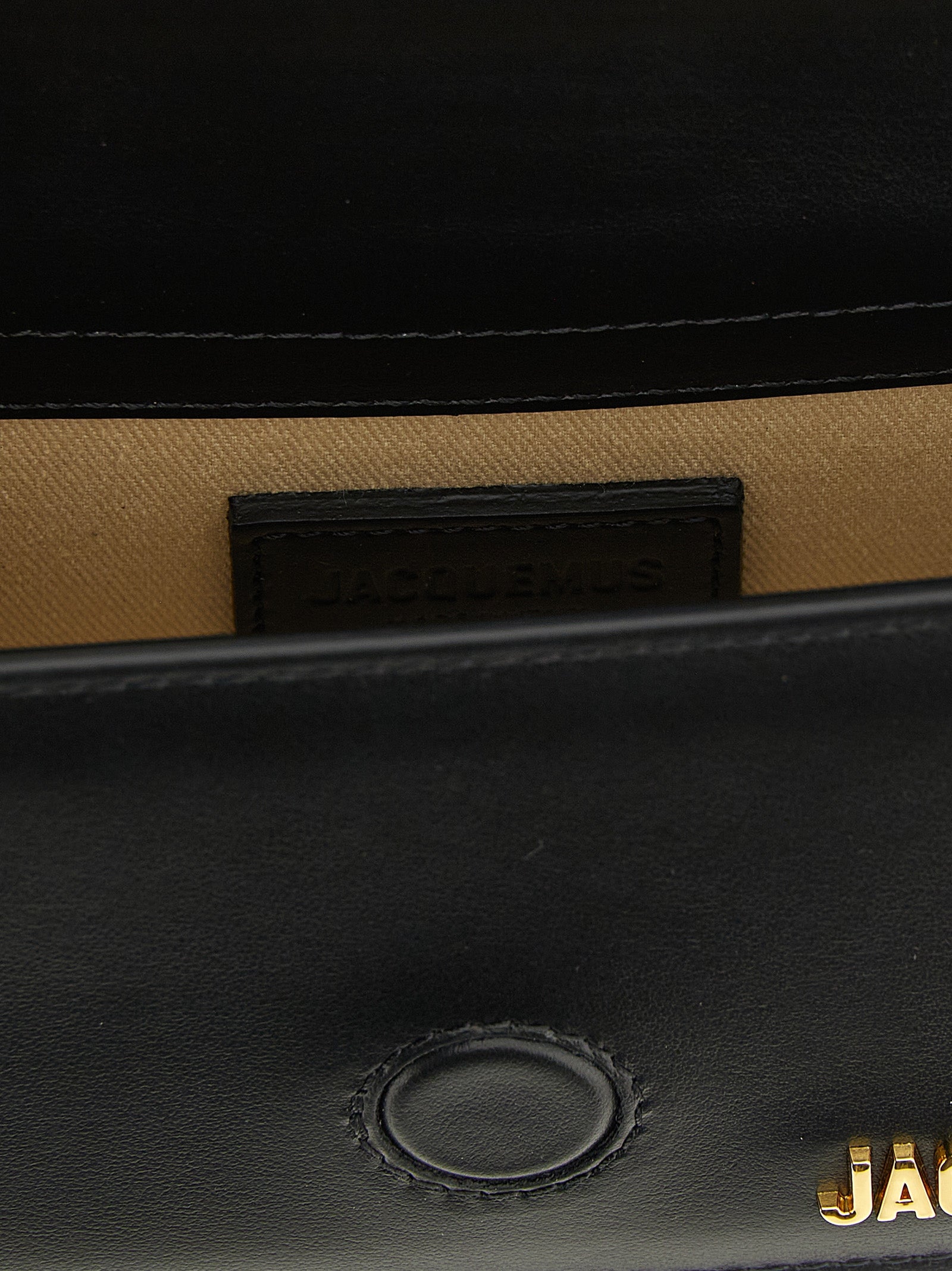 Black Jacquemus cowhide handbag with sleek design, featuring a structured shape and top handle for a chic, modern look.