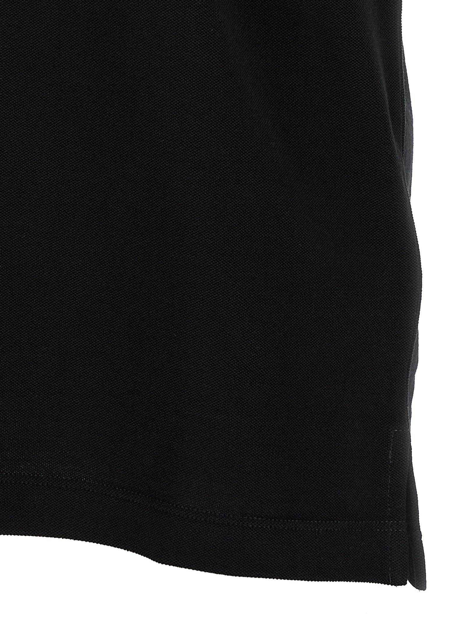 Black cotton polo shirt by Fendi featuring a classic collar and short sleeves, displayed on a plain background.