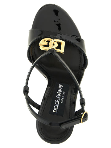 Black calfskin stiletto heel sandals by Dolce & Gabbana featuring strappy design and high slender heels.