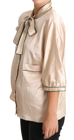 Beige silk stretch top blouse with ribbon detail by Dolce & Gabbana, featuring a fitted style and elegant neckline.