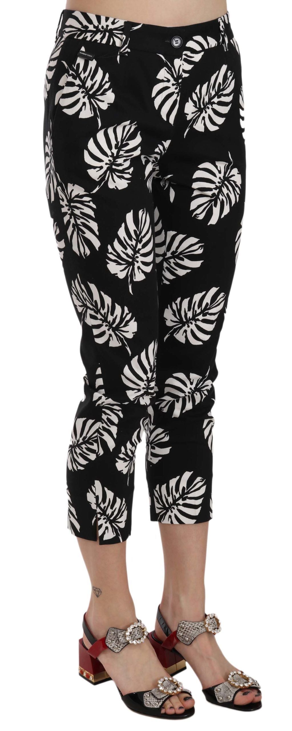 Black palm leaf print skinny pants by Dolce & Gabbana, featuring a fitted silhouette and bold tropical pattern.