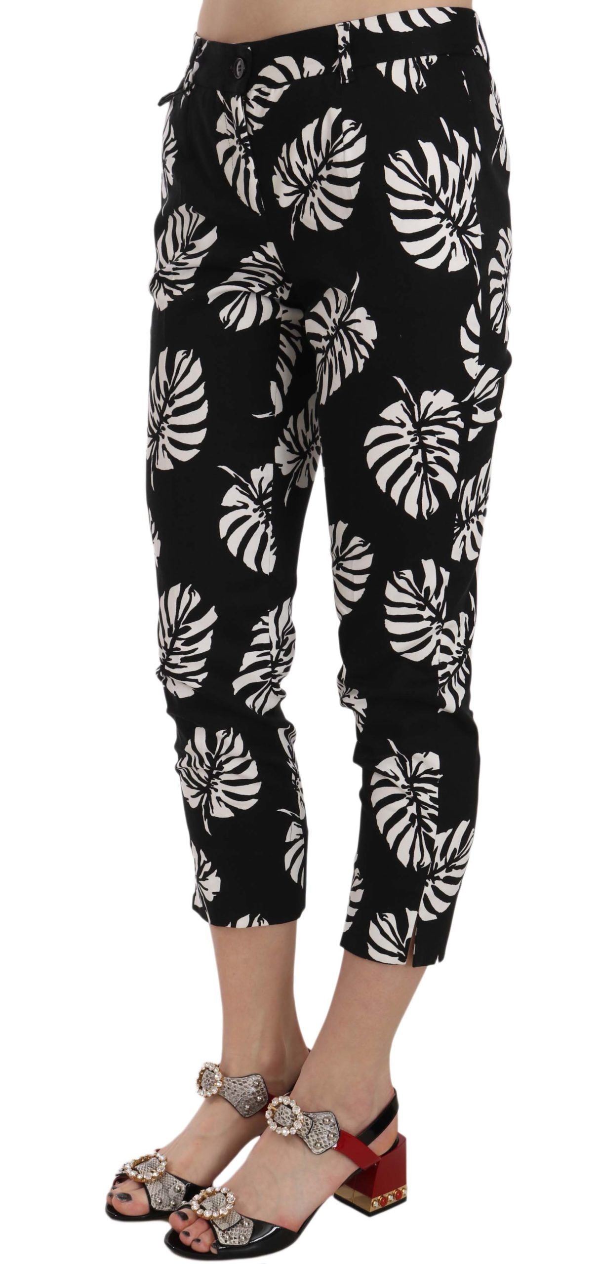 Black palm leaf print skinny pants by Dolce & Gabbana, showcasing a fitted design with bold botanical pattern.