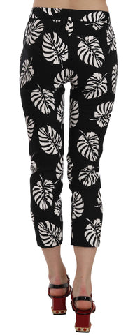 Black palm leaf print skinny pants by Dolce & Gabbana, featuring a fitted silhouette and tropical leaf pattern.