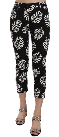 Black palm leaf print skinny pants by Dolce & Gabbana, featuring a slim fit and bold tropical floral design.