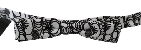 White patterned silk adjustable neck papillon tie by Dolce & Gabbana, featuring a stylish bow design and elegant fabric.