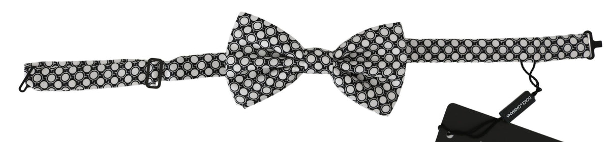 Men's black and white circle pattern adjustable neck papillon bow tie by Dolce & Gabbana, featuring classic design and fabric texture.