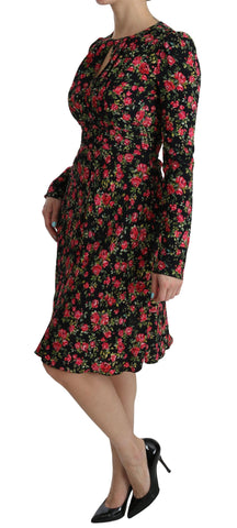Black floral long-sleeve knee-length dress by Dolce & Gabbana with a fitted waist and elegant floral pattern.