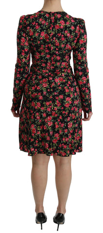 Black floral longsleeve knee-length dress by Dolce & Gabbana, featuring elegant floral pattern and fitted silhouette.