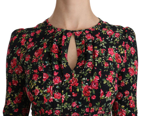 Black floral long-sleeve knee-length dress by Dolce & Gabbana, featuring elegant fabric and detailed floral pattern.