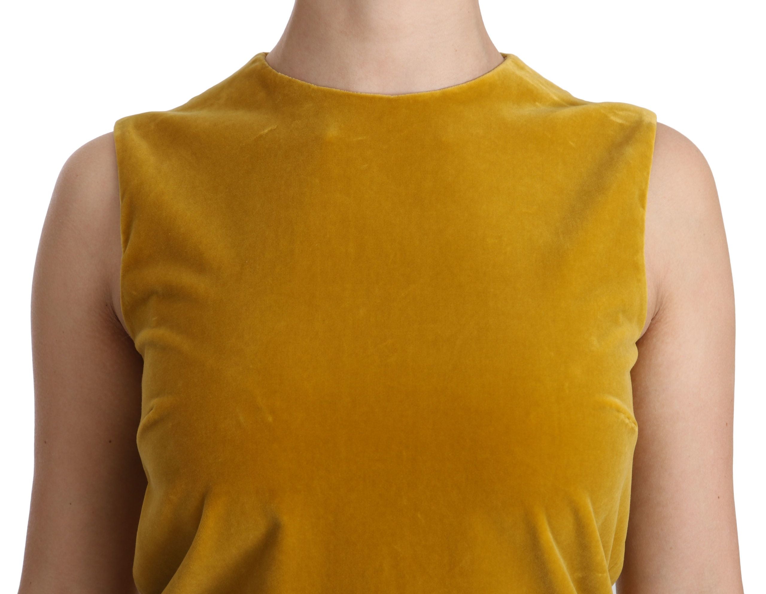Dolce & Gabbana mustard velvet stretch shift mini dress displayed on a hanger, showcasing its smooth fabric and elegant silhouette.