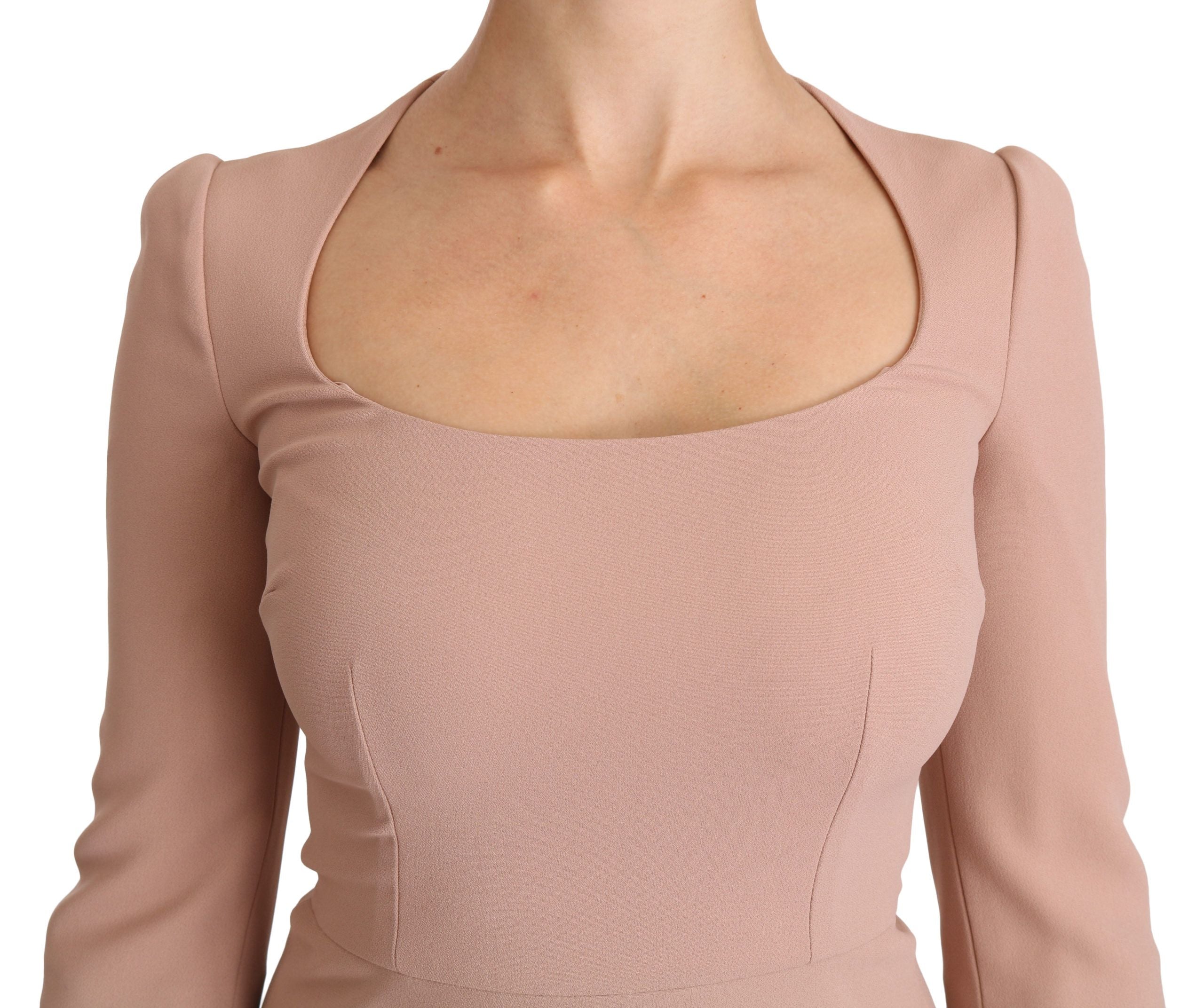 Pink Dolce & Gabbana 3/4 sleeve A-line viscose dress hanging on a rack, showcasing its elegant V-neck and flowing fabric.