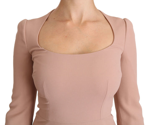 Pink Dolce & Gabbana 3/4 sleeve A-line viscose dress hanging on a rack, showcasing its elegant V-neck and flowing fabric.