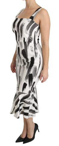 White and black printed sheath midi dress made of viscose by Dolce & Gabbana, displayed on a hanger.