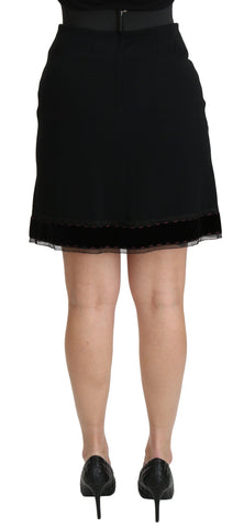 Black A-line high waist mini skirt made of viscose, by Dolce & Gabbana, shown on a model with a sleek, stylish fit.