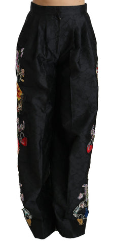 Black brocade floral sequined beaded pants by Dolce & Gabbana, featuring intricate floral patterns and shimmering beadwork.