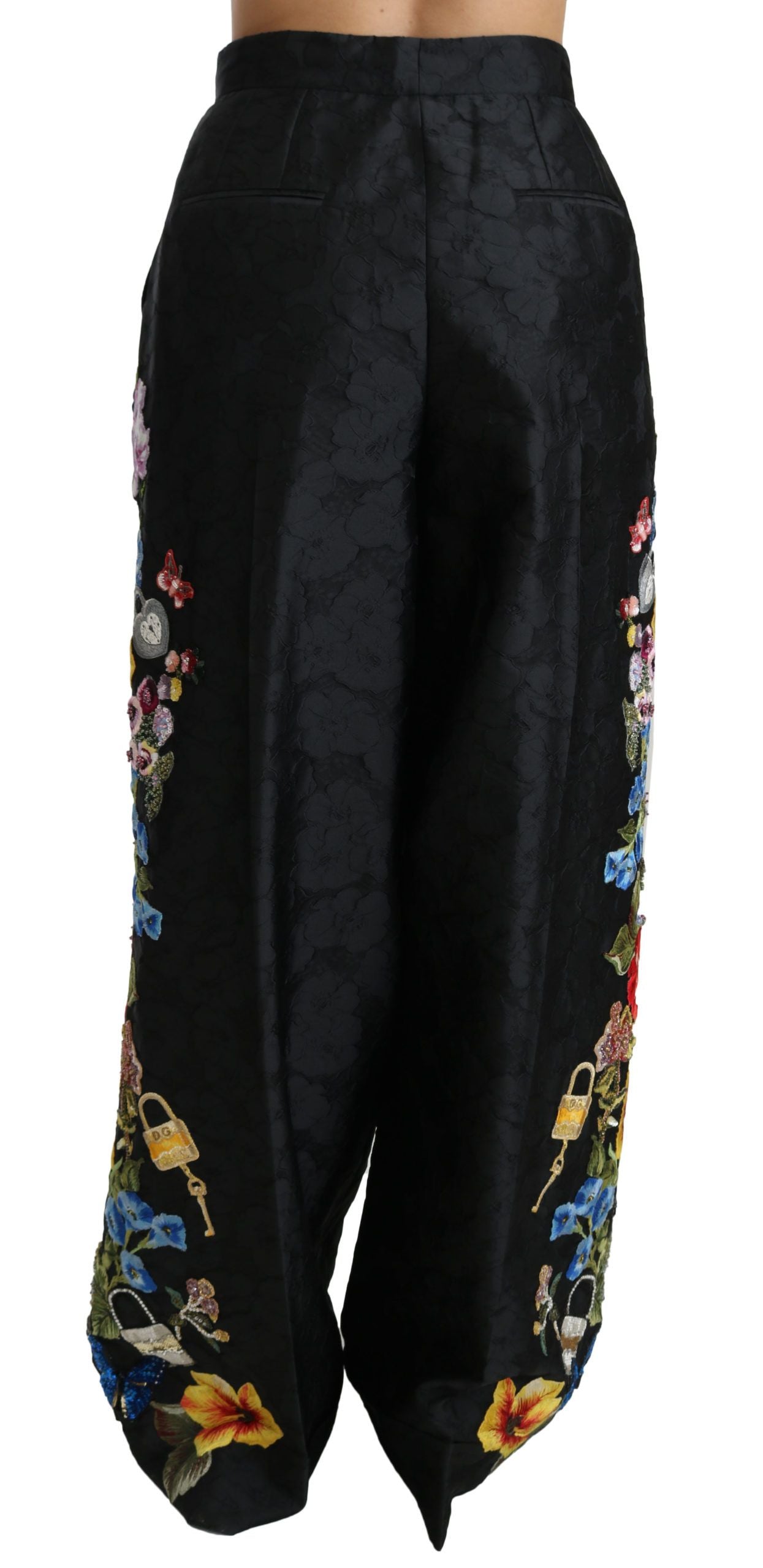 Black brocade floral sequined beaded pants by Dolce & Gabbana with intricate floral patterns and shimmering embellishments.