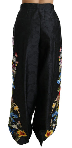 Black brocade floral sequined beaded pants by Dolce & Gabbana with intricate floral patterns and shimmering embellishments.