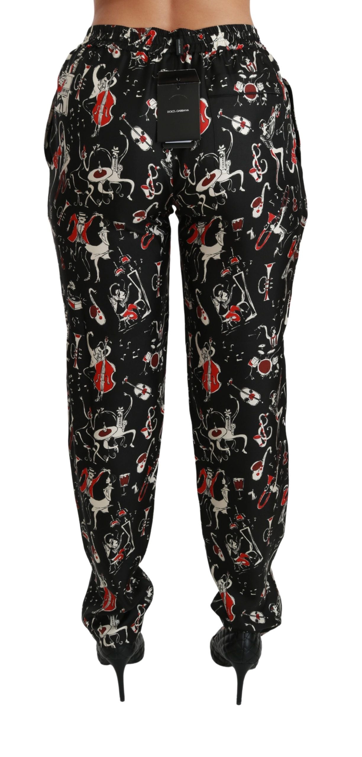 Black silk instrument mid-rise pants by Dolce & Gabbana, featuring a sleek, tailored design with a smooth waistband.