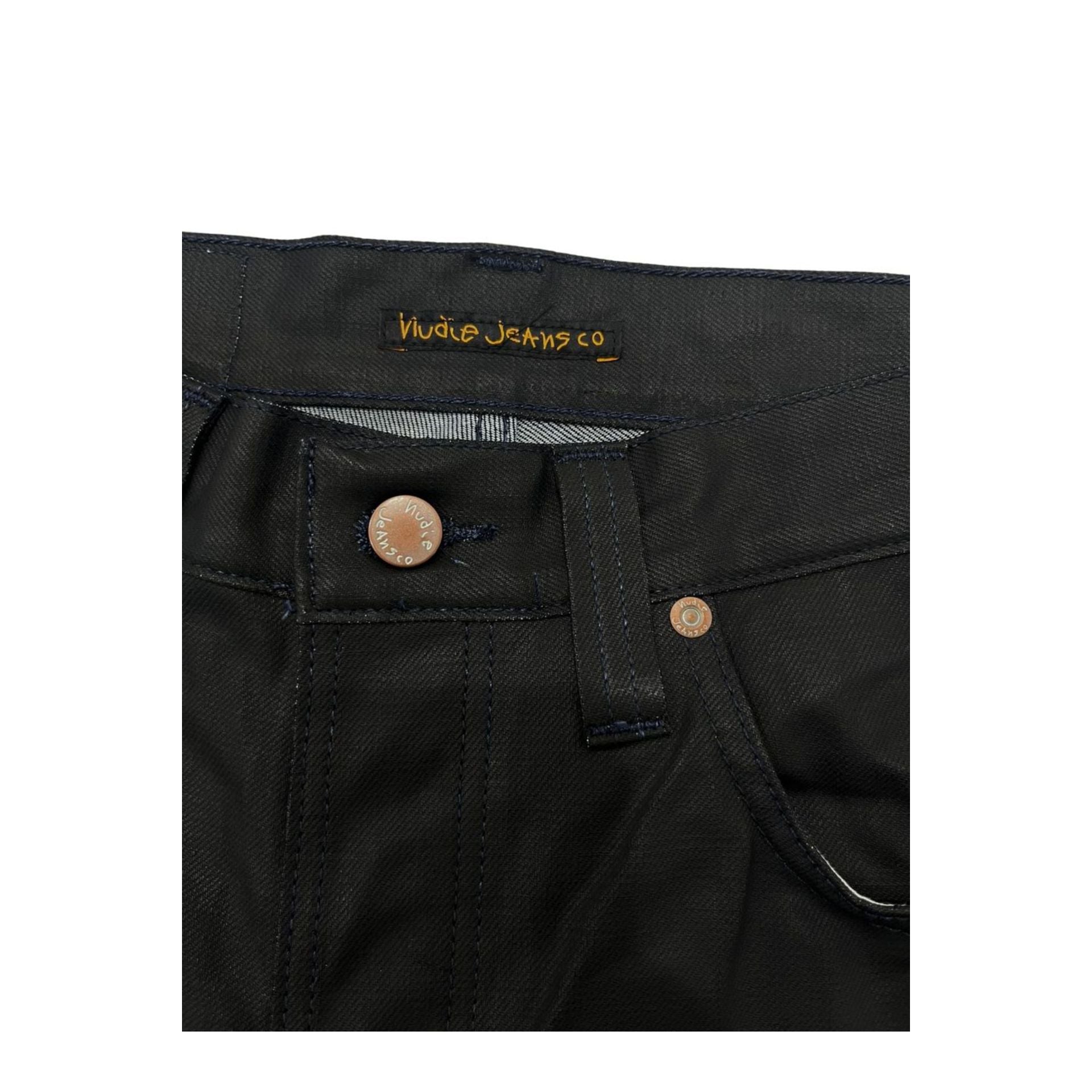 Nudie Jeans NJ3008GRIMTIM_NeroBlack in black denim, displayed on a hanger with visible stitching and metal rivets.