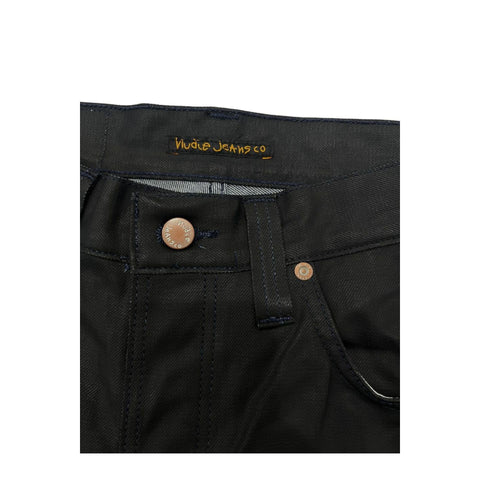 Nudie Jeans NJ3008GRIMTIM_NeroBlack in black denim, displayed on a hanger with visible stitching and metal rivets.