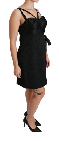 Black stretch satin jacquard mini dress by Dolce & Gabbana, shown with a fitted silhouette and intricate fabric pattern.