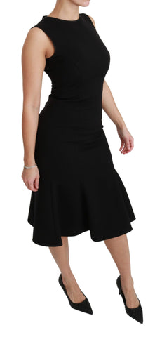 Black Dolce & Gabbana fit flare wool stretch sheath dress displayed on a hanger, showcasing its tailored silhouette and fabric details.