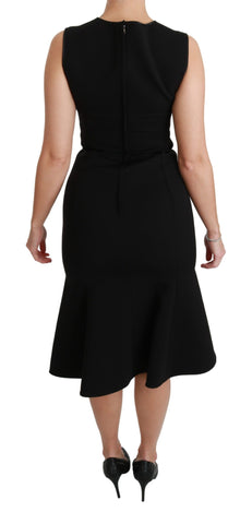 Black Dolce & Gabbana fit and flare wool stretch sheath dress displayed on a hanger with a smooth background.