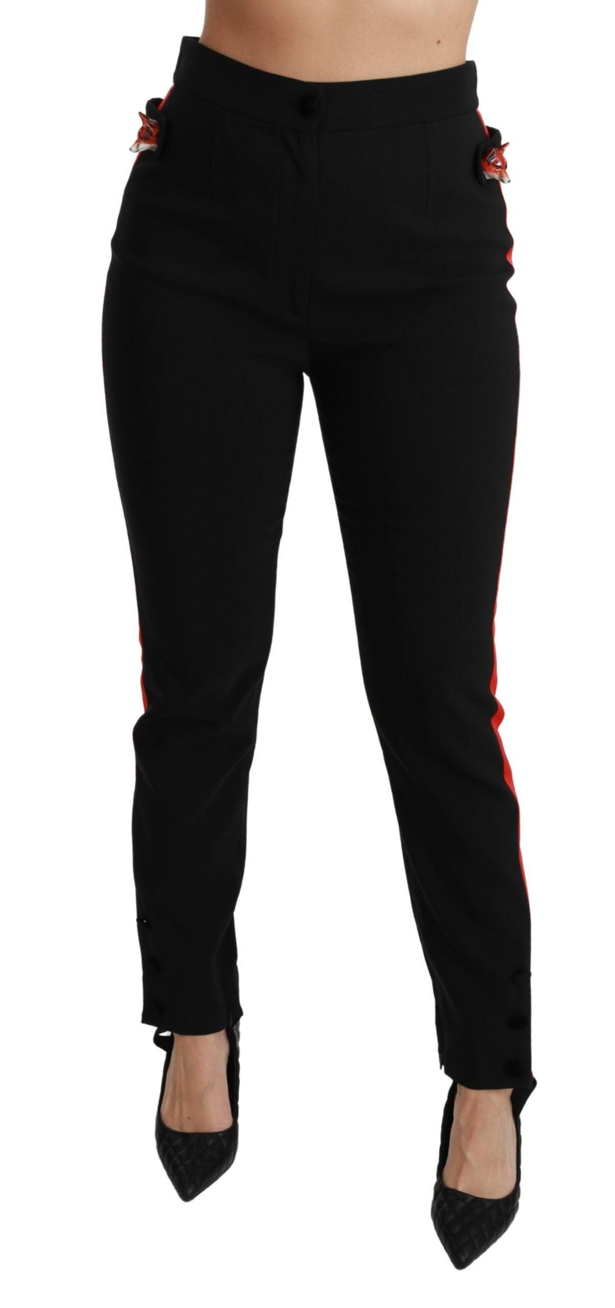 Black skinny stretch cotton pants with fox head print from Dolce & Gabbana, close-up view showing fit and fabric texture.