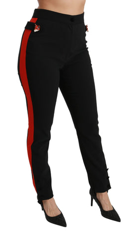 Black skinny stretch cotton pants with fox head detail from Dolce & Gabbana, close-up view of the fitted waist and fabric texture.