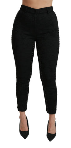 Black brocade skinny high-waist pants by Dolce & Gabbana, showing detailed textured fabric and sleek fit.