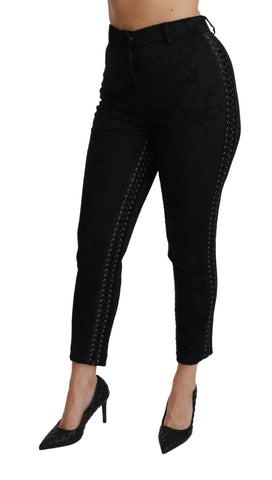 Black brocade skinny high-waist pants by Dolce & Gabbana, showing detailed floral pattern and fitted silhouette.