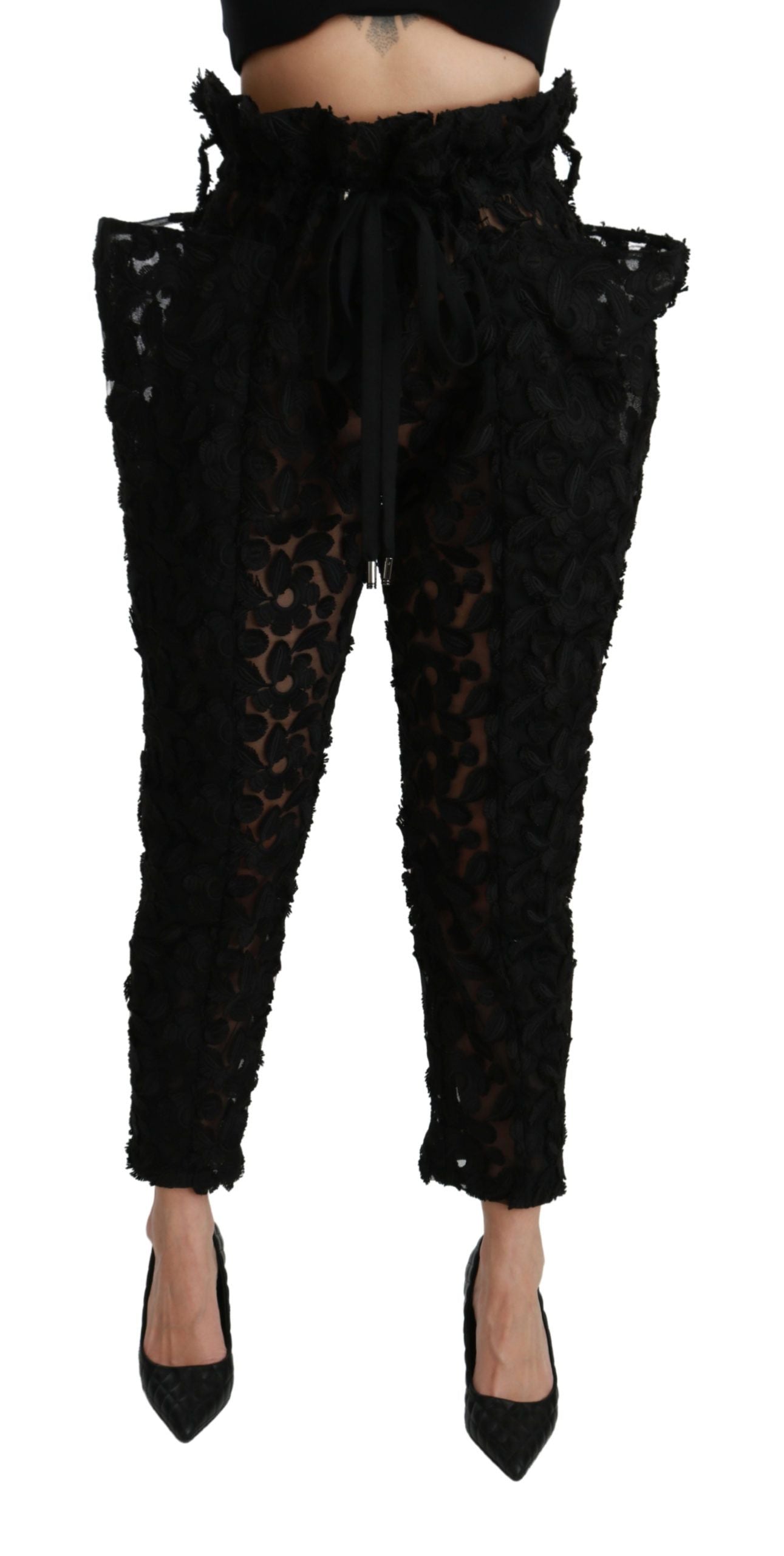 Black floral lace tapered high waist pants by Dolce & Gabbana with intricate lace detailing and a fitted silhouette.