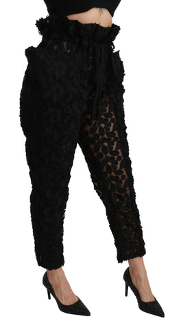 Black floral lace tapered high waist pants by Dolce & Gabbana, showing intricate lace details and sleek high-waist fit.