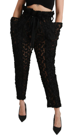 Black floral lace tapered high waist pants by Dolce & Gabbana with intricate lace detailing and a sleek high-rise fit.