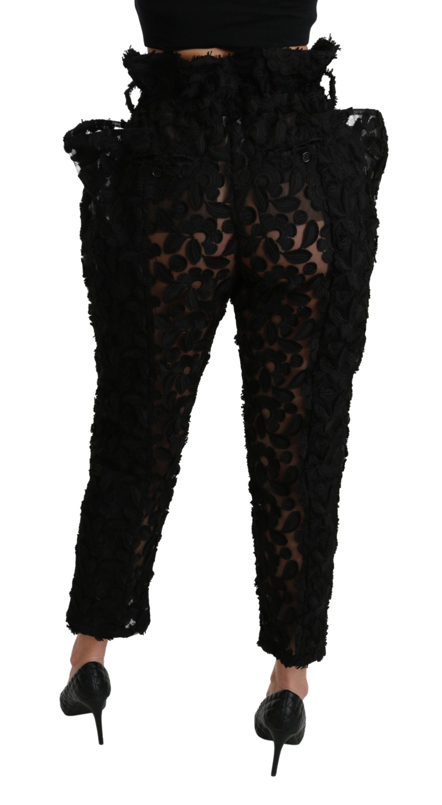 Black floral lace tapered high waist pants by Dolce & Gabbana, featuring intricate lace fabric and a fitted high-rise design.