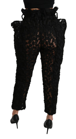 Black floral lace tapered high waist pants by Dolce & Gabbana, featuring intricate lace fabric and a fitted high-rise design.