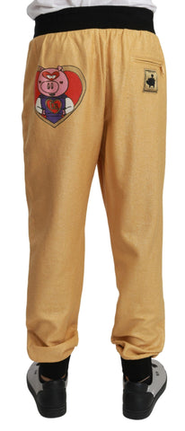 Gold cotton men's pants featuring a Year Of The Pig design by Dolce & Gabbana, shown with waistband and front pockets.