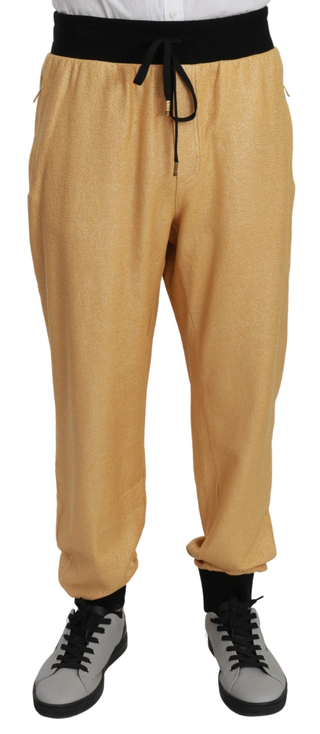 Gold cotton men's pants featuring a Year of the Pig design from Dolce & Gabbana, shown on a model.