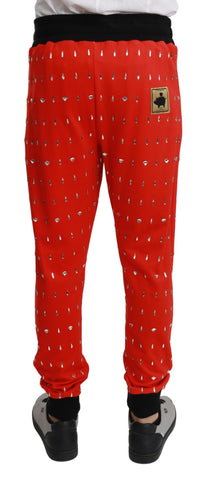 Red piggy bank-shaped cotton trousers by Dolce & Gabbana, featuring a playful piggy bank motif and tailored fit.