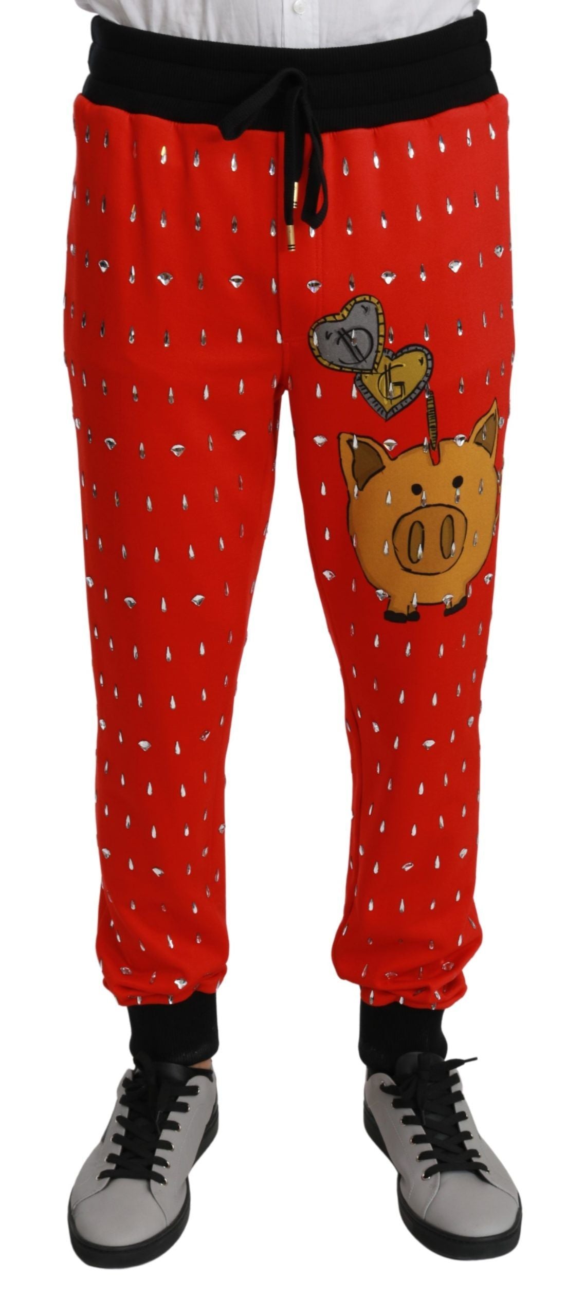Red piggy bank cotton trousers by Dolce & Gabbana, featuring crystal embellishments and a relaxed fit.