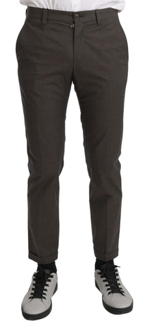 Brown casual men's trousers made of 100% cotton by Dolce & Gabbana, shown on a model with a relaxed fit and classic design.