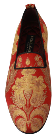 Red gold brocade loafers by Dolce & Gabbana featuring intricate fabric and classic slip-on design.